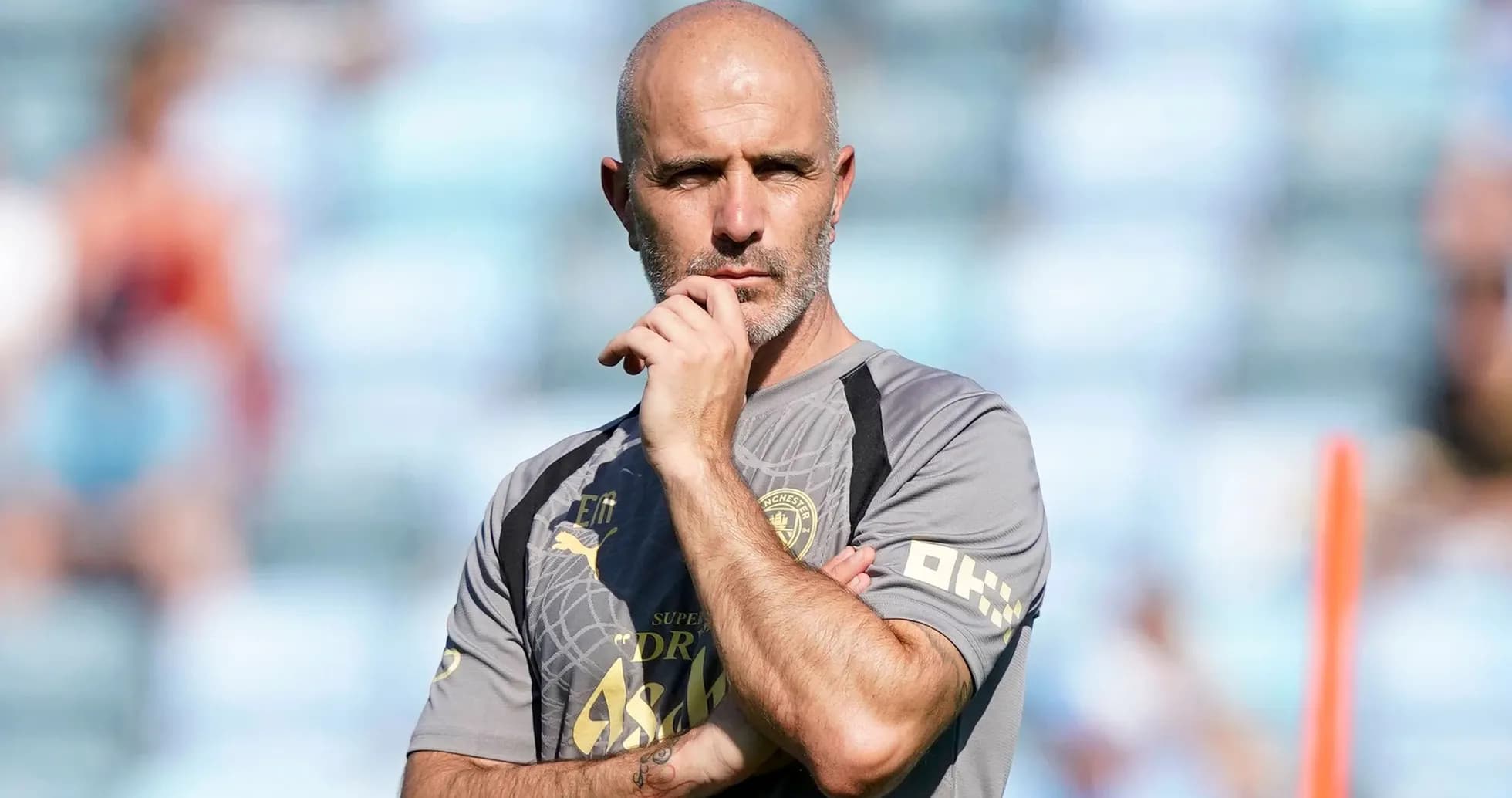 Coach observing training session with thoughtful expression