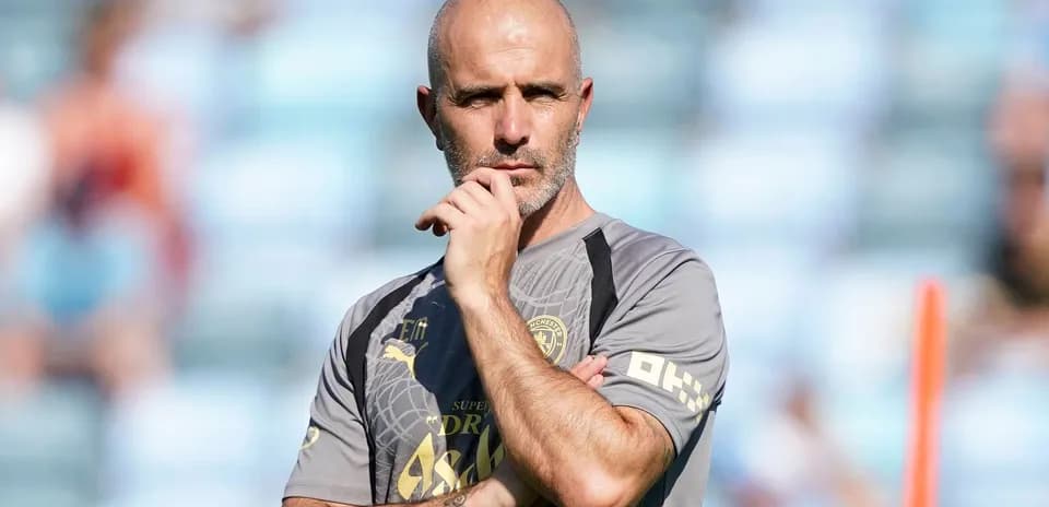 Coach observing training session with thoughtful expression