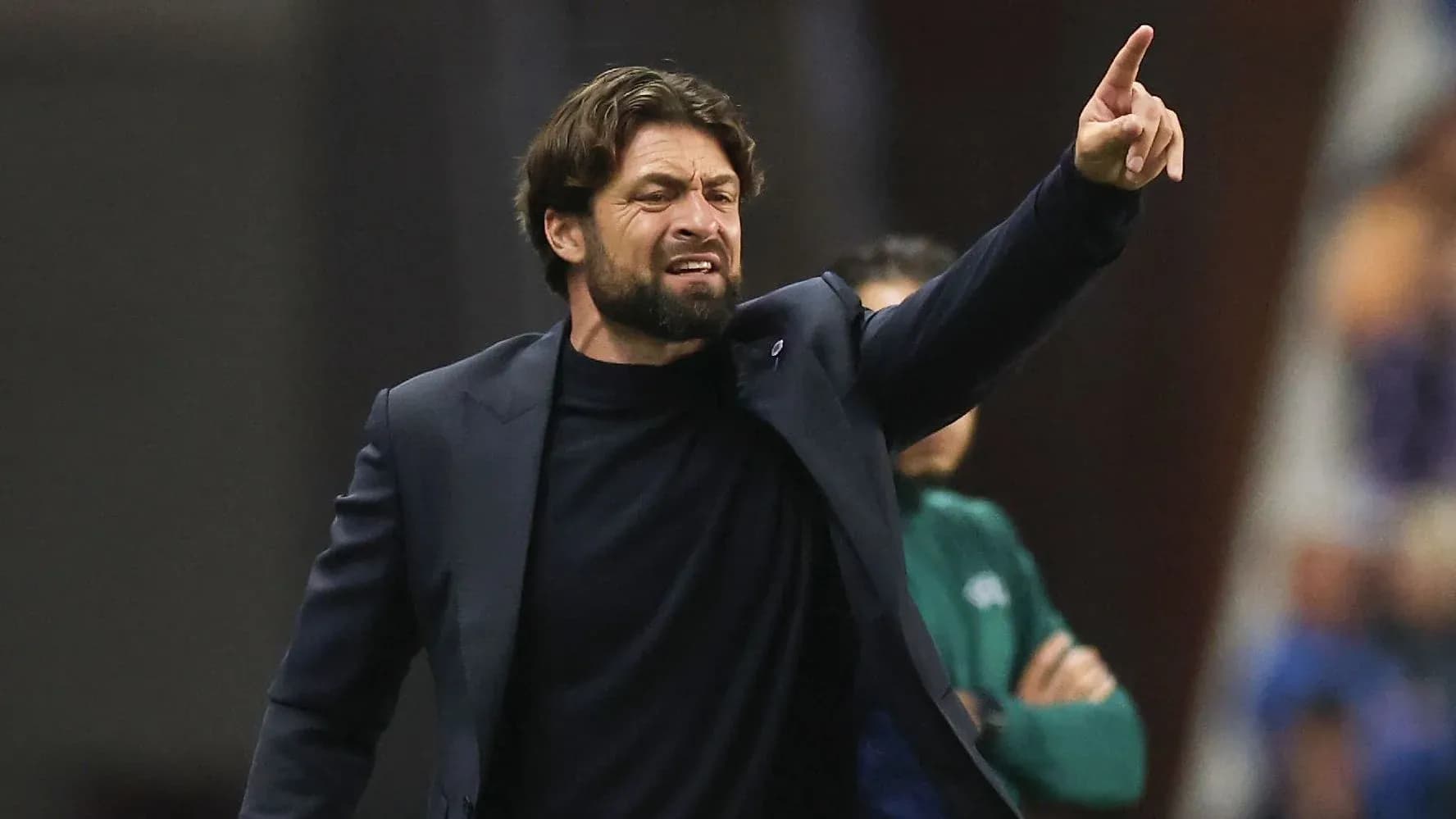 Coach gesturing and giving instructions during match