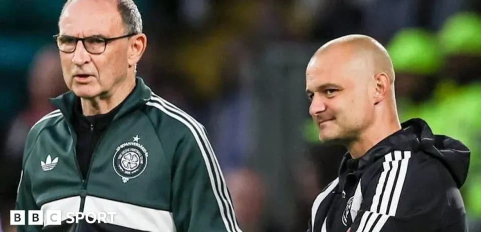 Two football coaches discussing on the sidelines