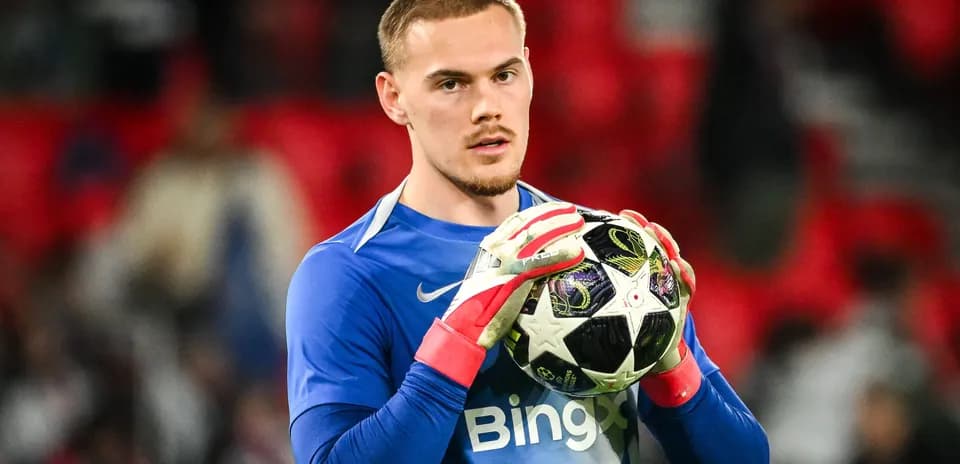 Goalkeeper holding football before match kickoff