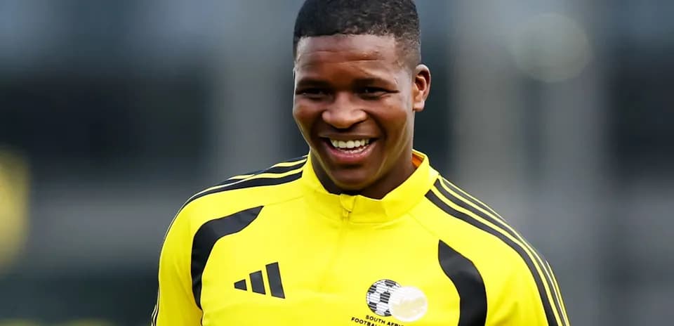 Player smiling in yellow training kit