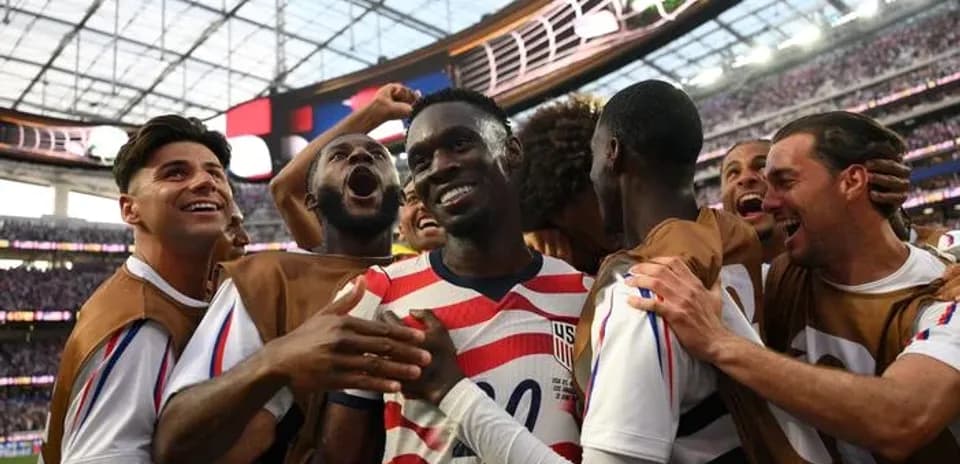 US team celebrating a goal during match