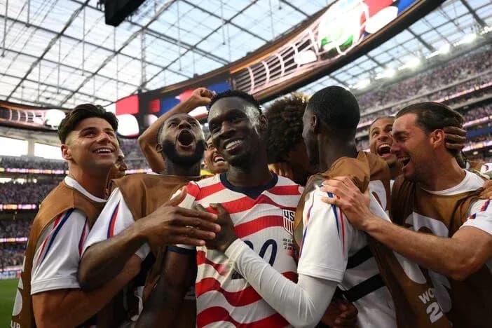 US team celebrating a goal during match