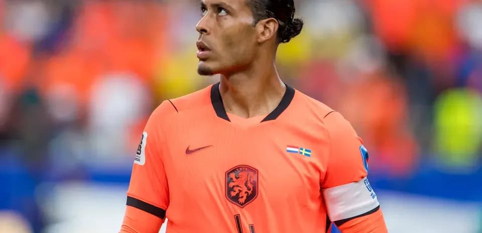 Player in orange kit looking up during match