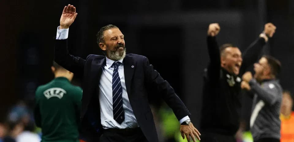 Coach celebrating with raised hand during match