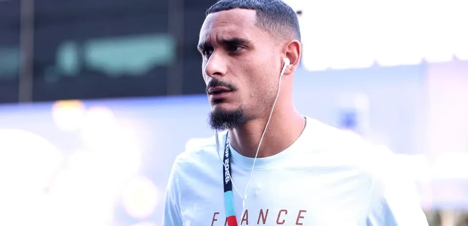 Player wearing headphones, walking in casual attire