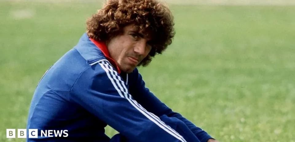 Athlete sitting on grass field in training attire