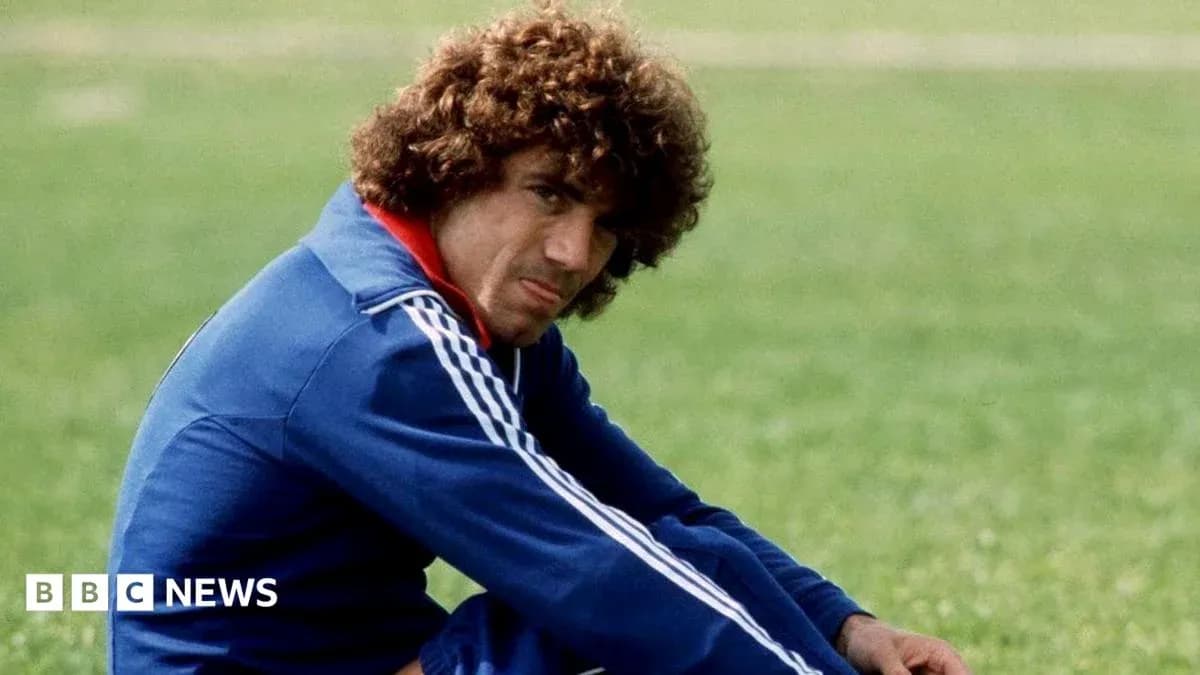Athlete sitting on grass field in training attire