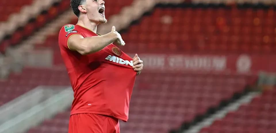 Player celebrating while lifting his shirt after scoring