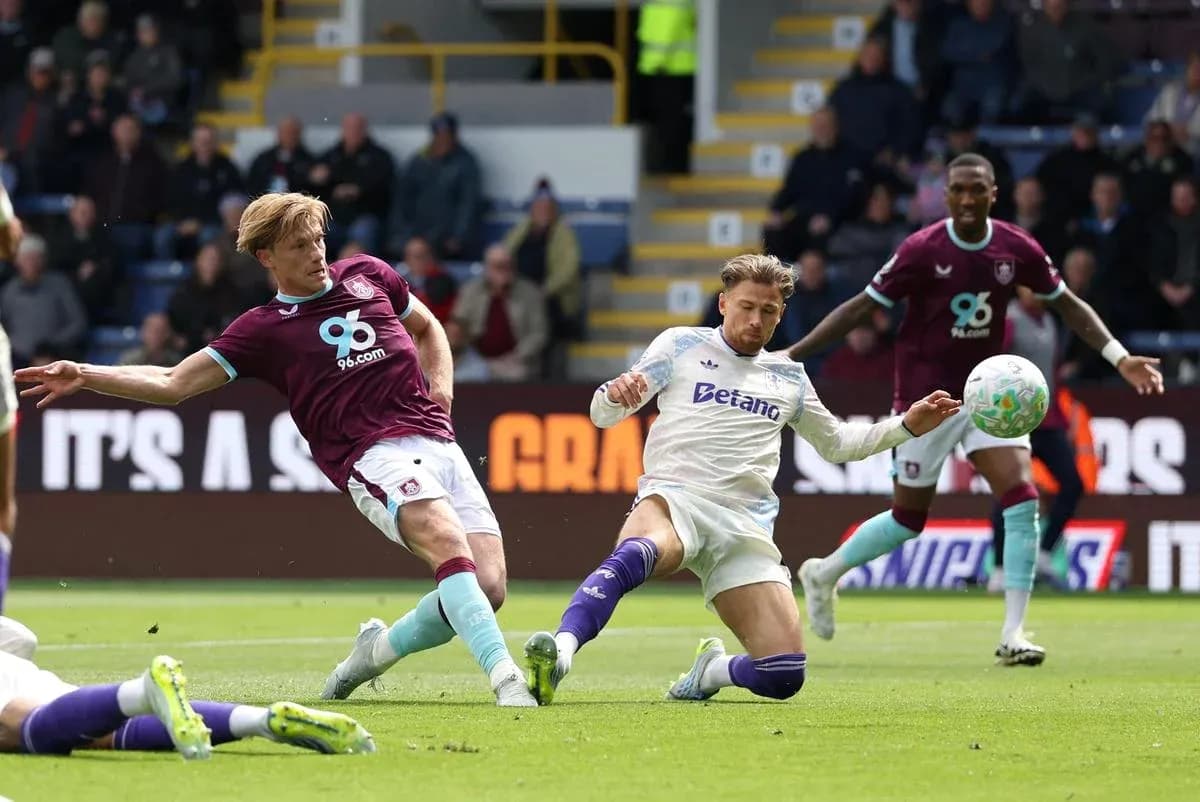 Burnley player challenging Aston Villa opponent