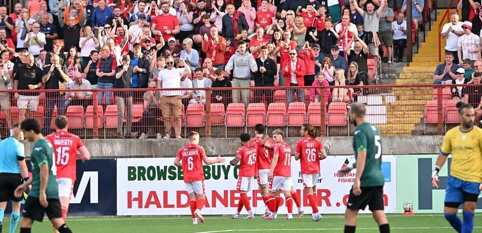 Fans celebrating during Larne football match