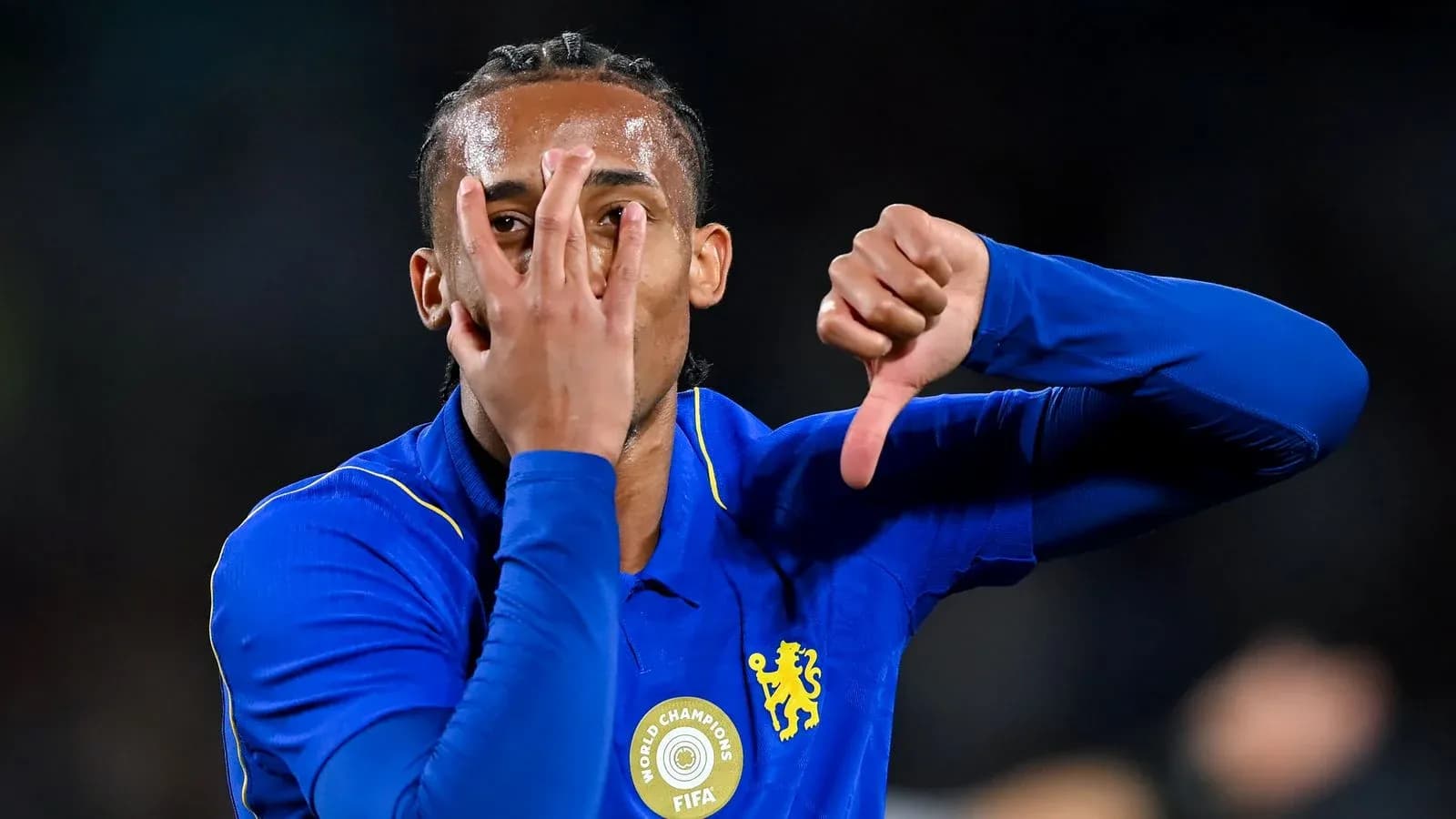 Player gesturing with hands during match celebration