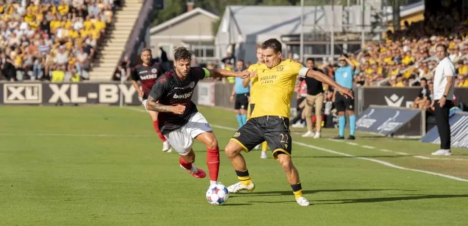 Player tackles opponent during UEFA Champions League match