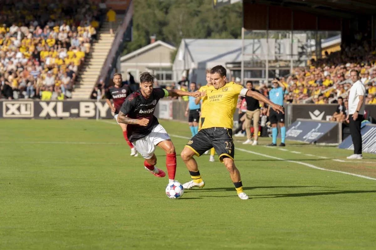 Player tackles opponent during UEFA Champions League match