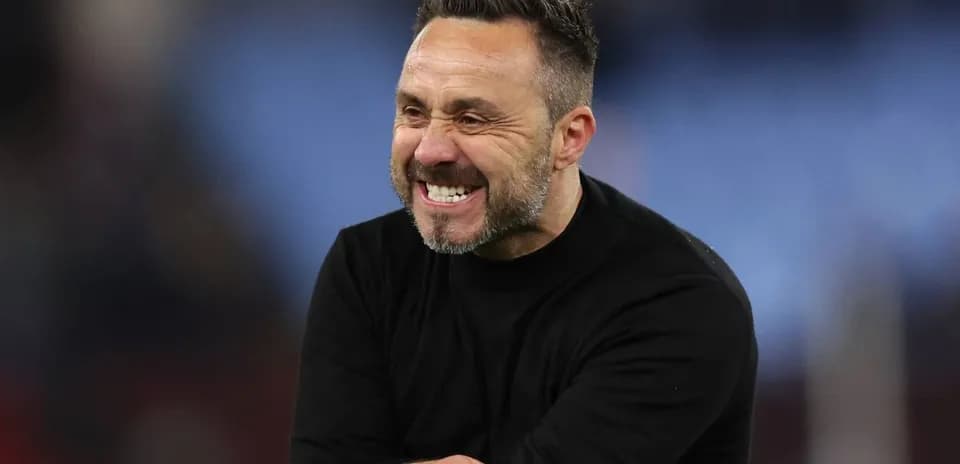 Coach celebrating during a match on the sidelines