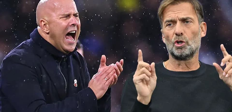 Two football managers speaking during a match