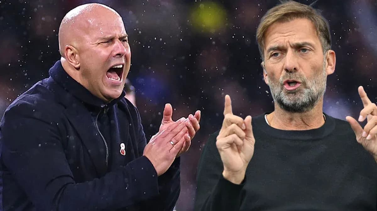 Two football managers speaking during a match
