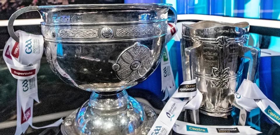 Two silver trophies with GAA ribbons displayed