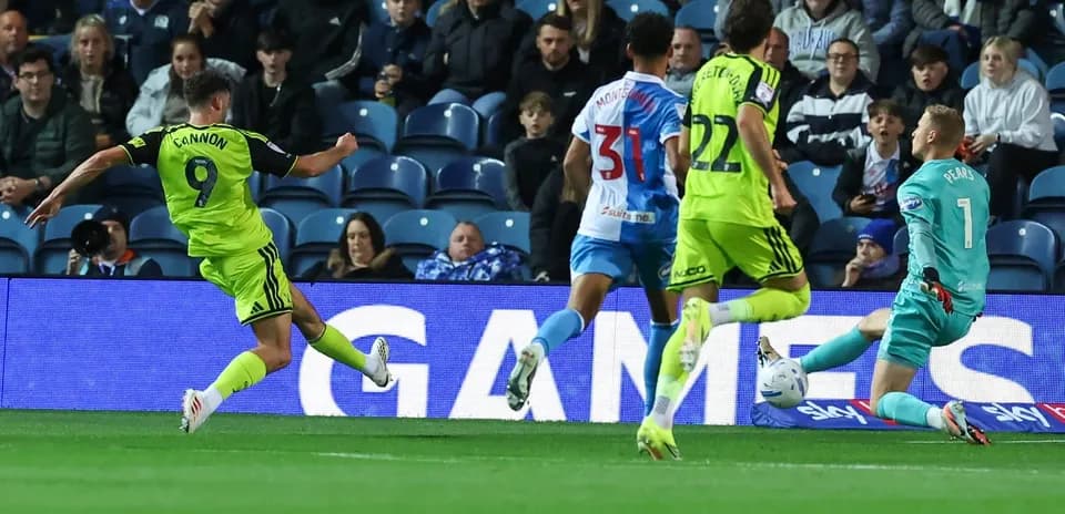 Player shooting on goal during football match