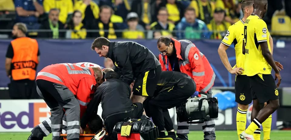 Medical staff attending to player on the field