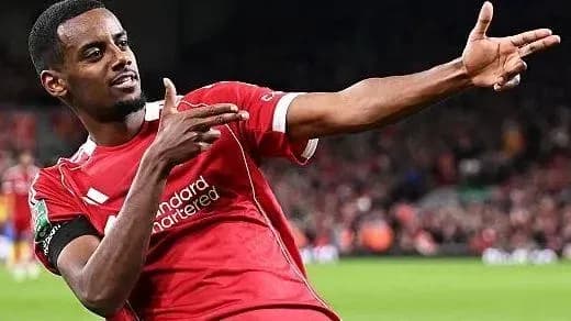 Player celebrating a goal in Liverpool jersey