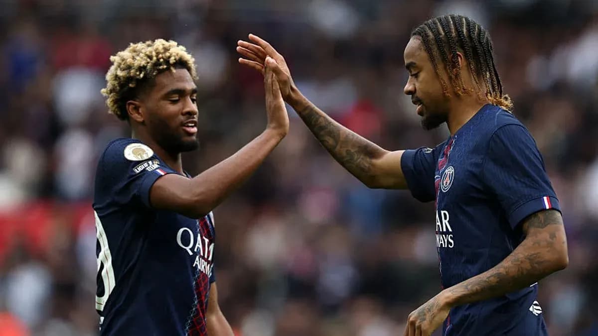 Two PSG players exchanging high-fives on the pitch