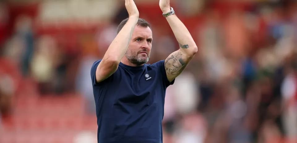 Coach applauding fans after a match