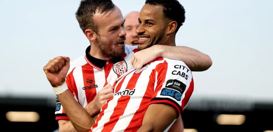 Two players celebrating a goal on the field