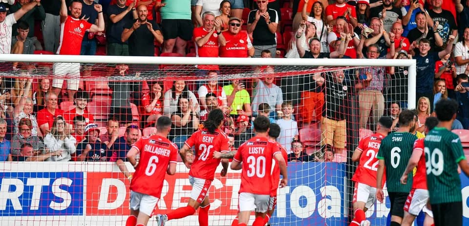 Larne players celebrating a goal during match
