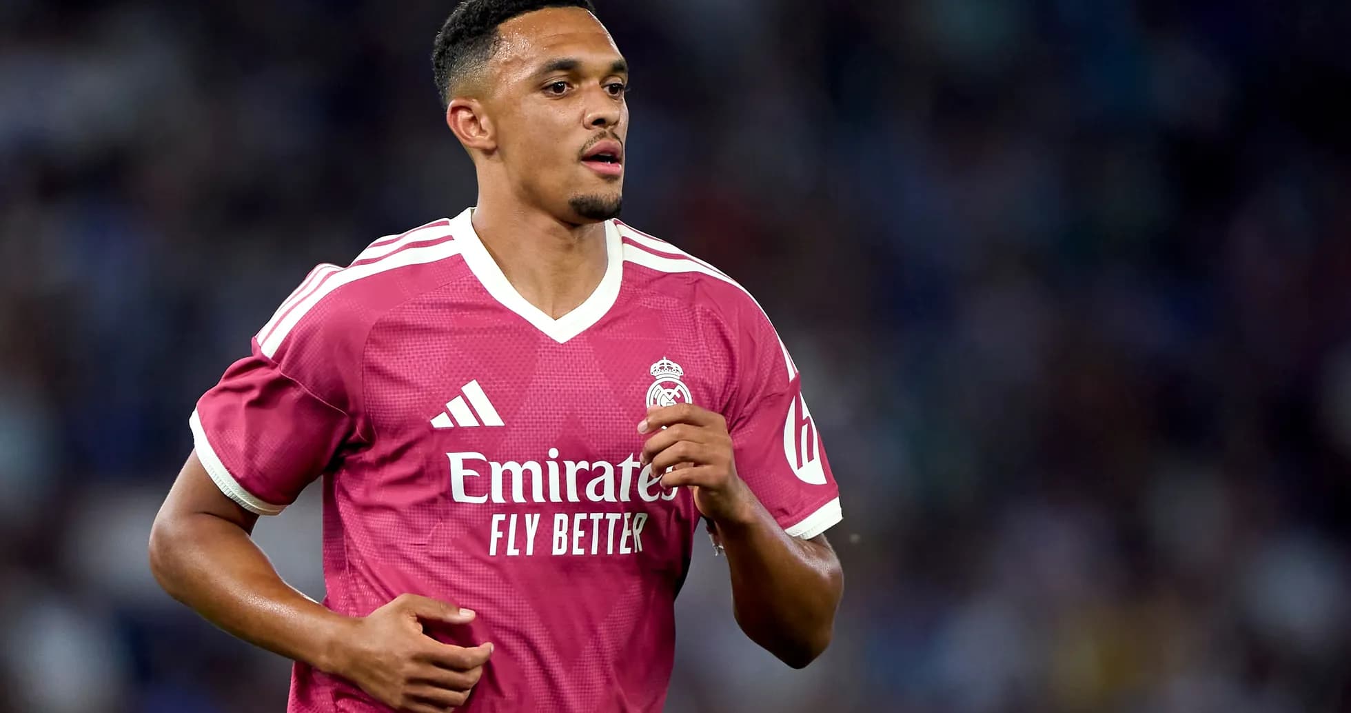 Player in pink Real Madrid jersey running on field
