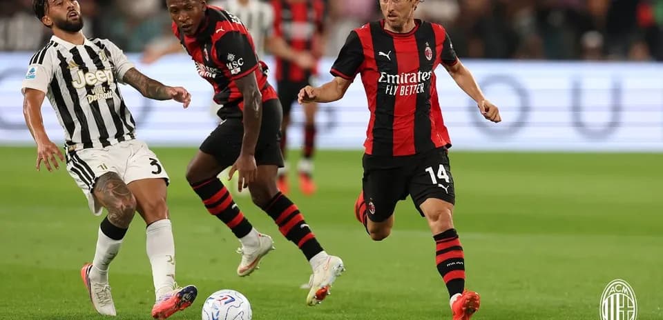 Juventus and AC Milan players competing for the ball