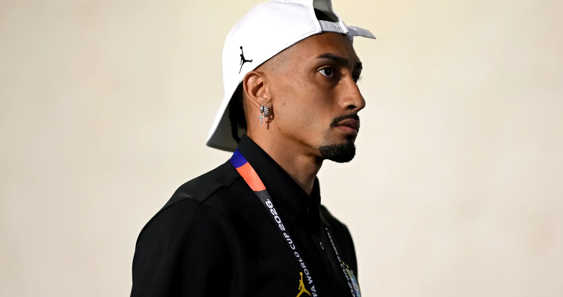 Person wearing cap and lanyard, profile view