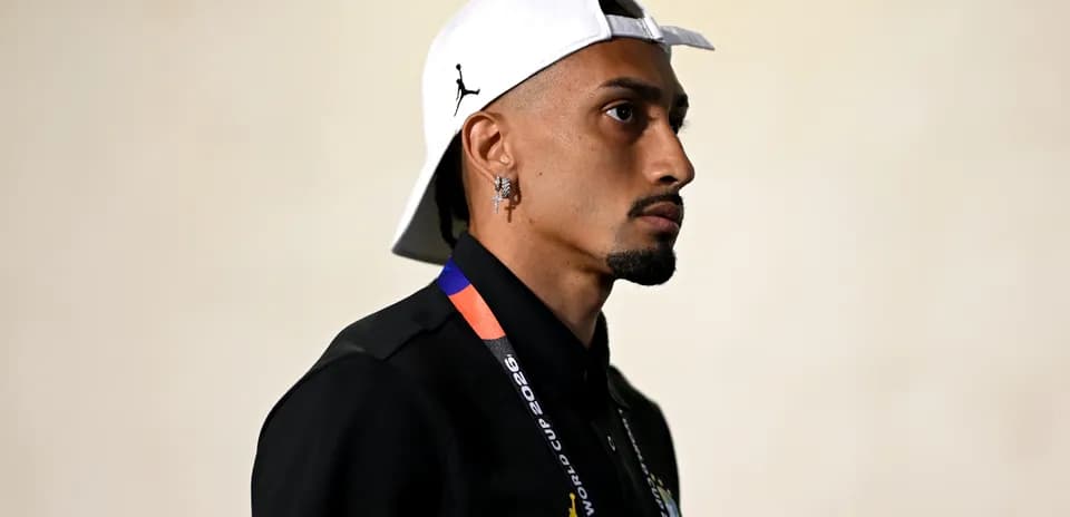 Person wearing cap and lanyard, profile view