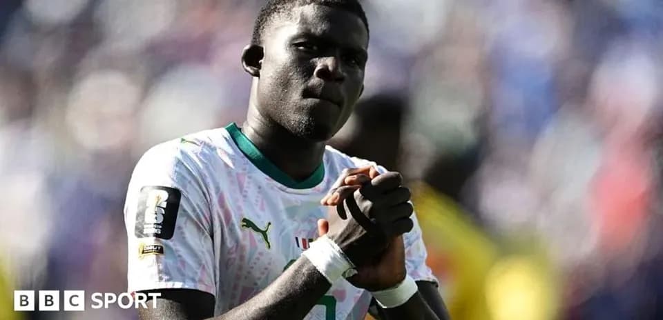 Player in national team jersey with clasped hands