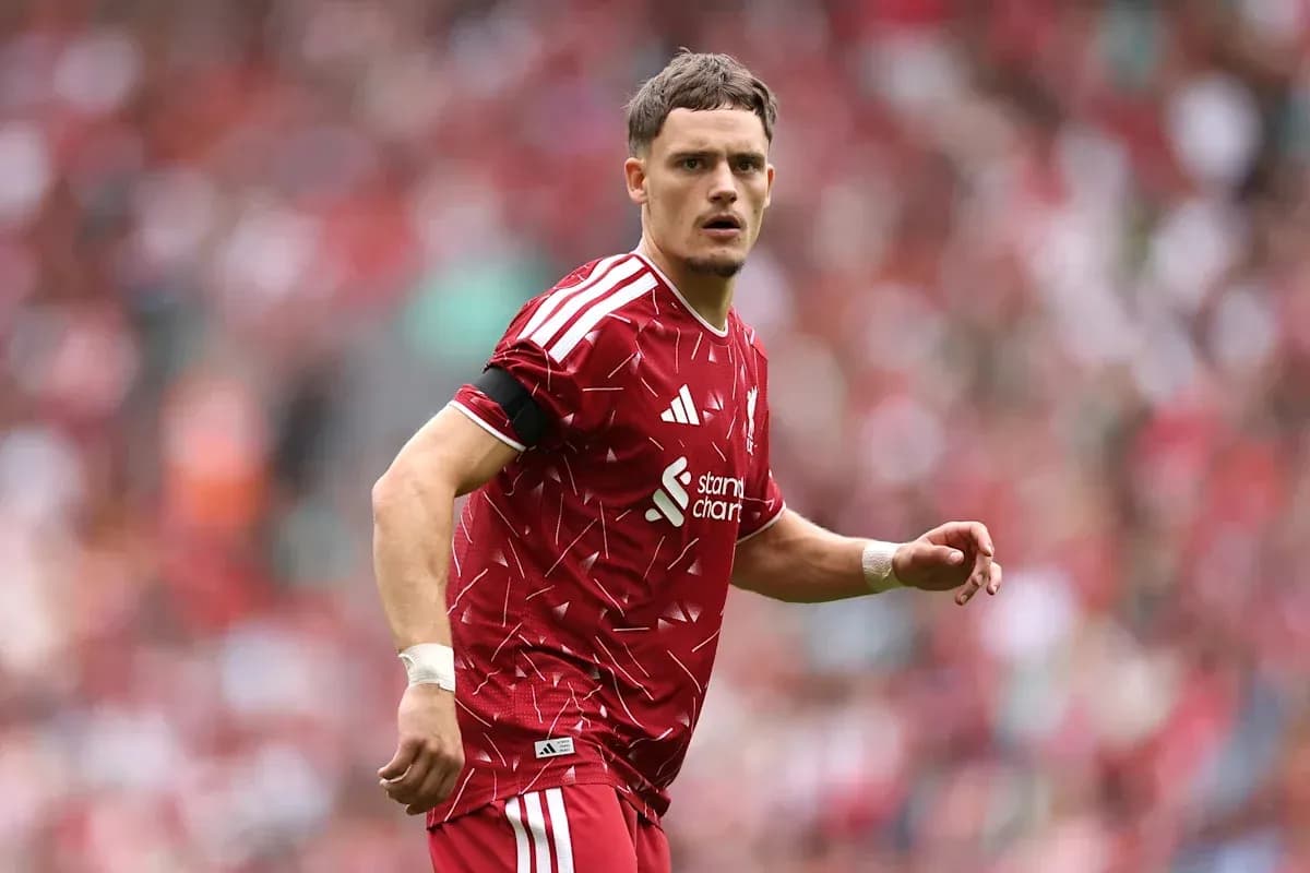 Player in red jersey on football pitch during match