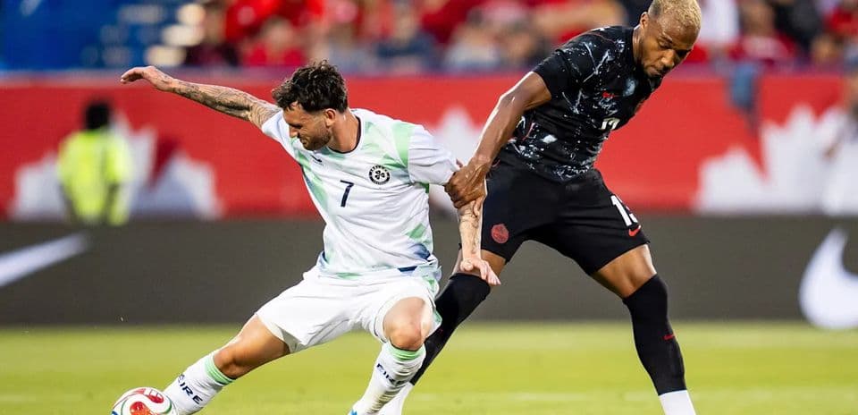 Two players competing for the ball on the field