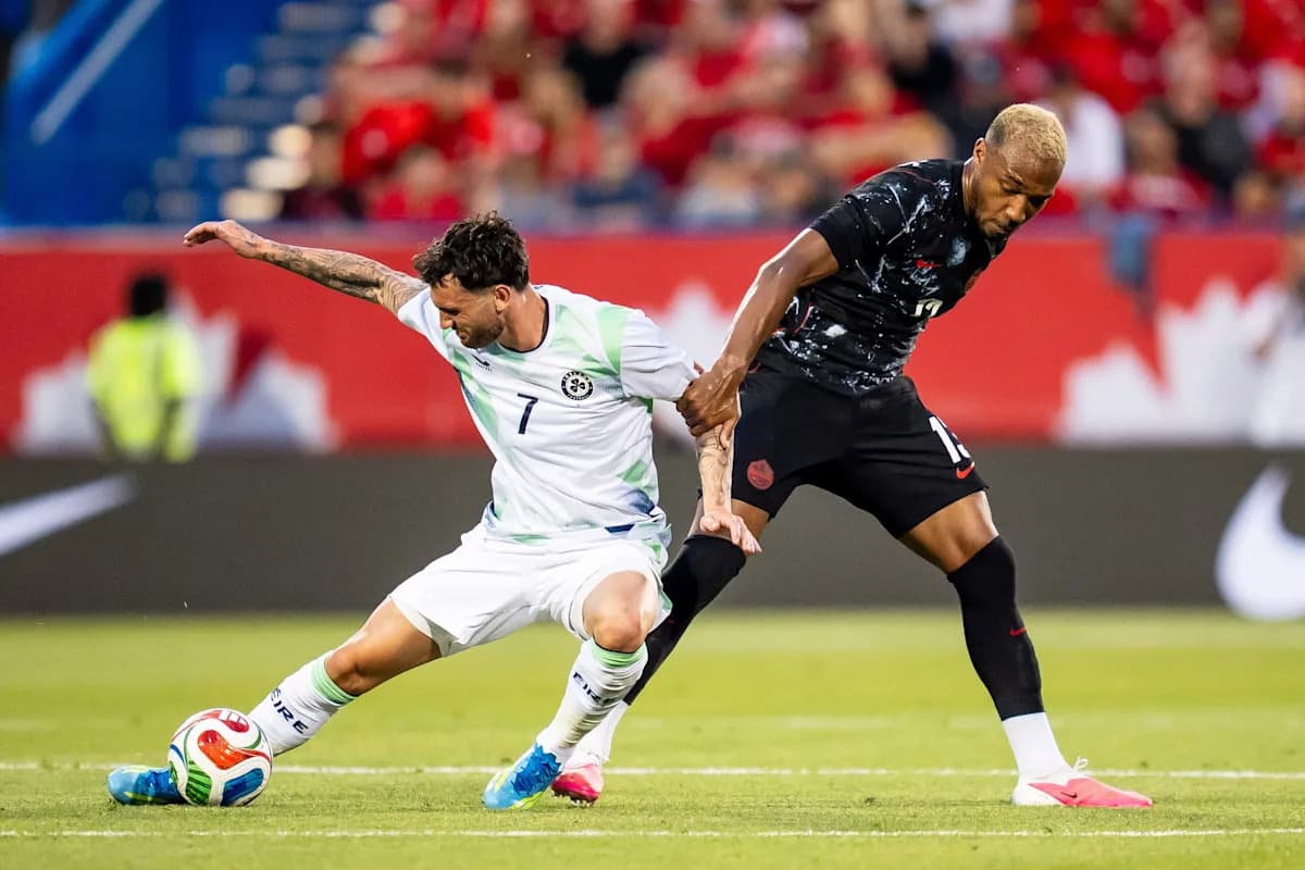 Two players competing for the ball on the field