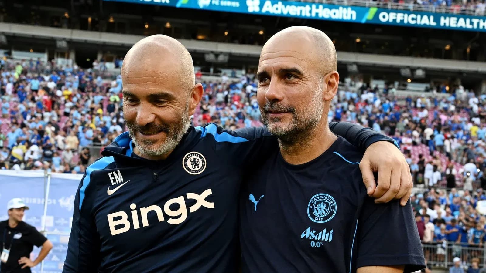 Two football coaches embracing after a match