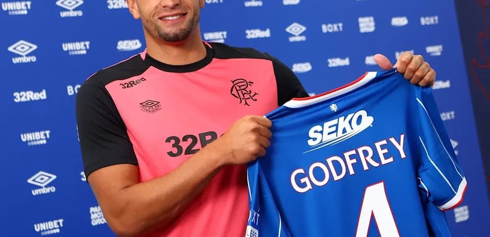 Player holding Rangers FC jersey with Godfrey number