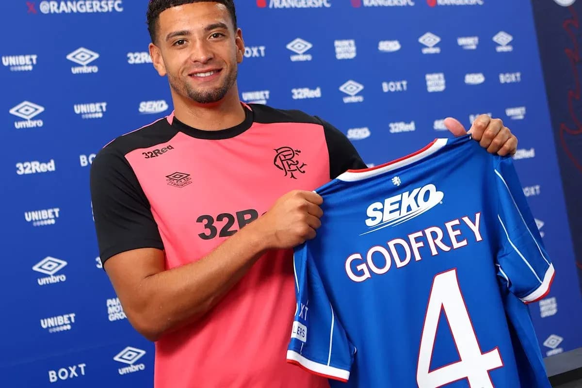 Player holding Rangers FC jersey with Godfrey number