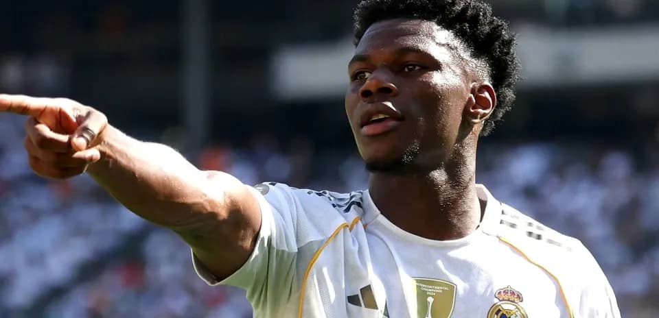 Player pointing during a match wearing Real Madrid jersey
