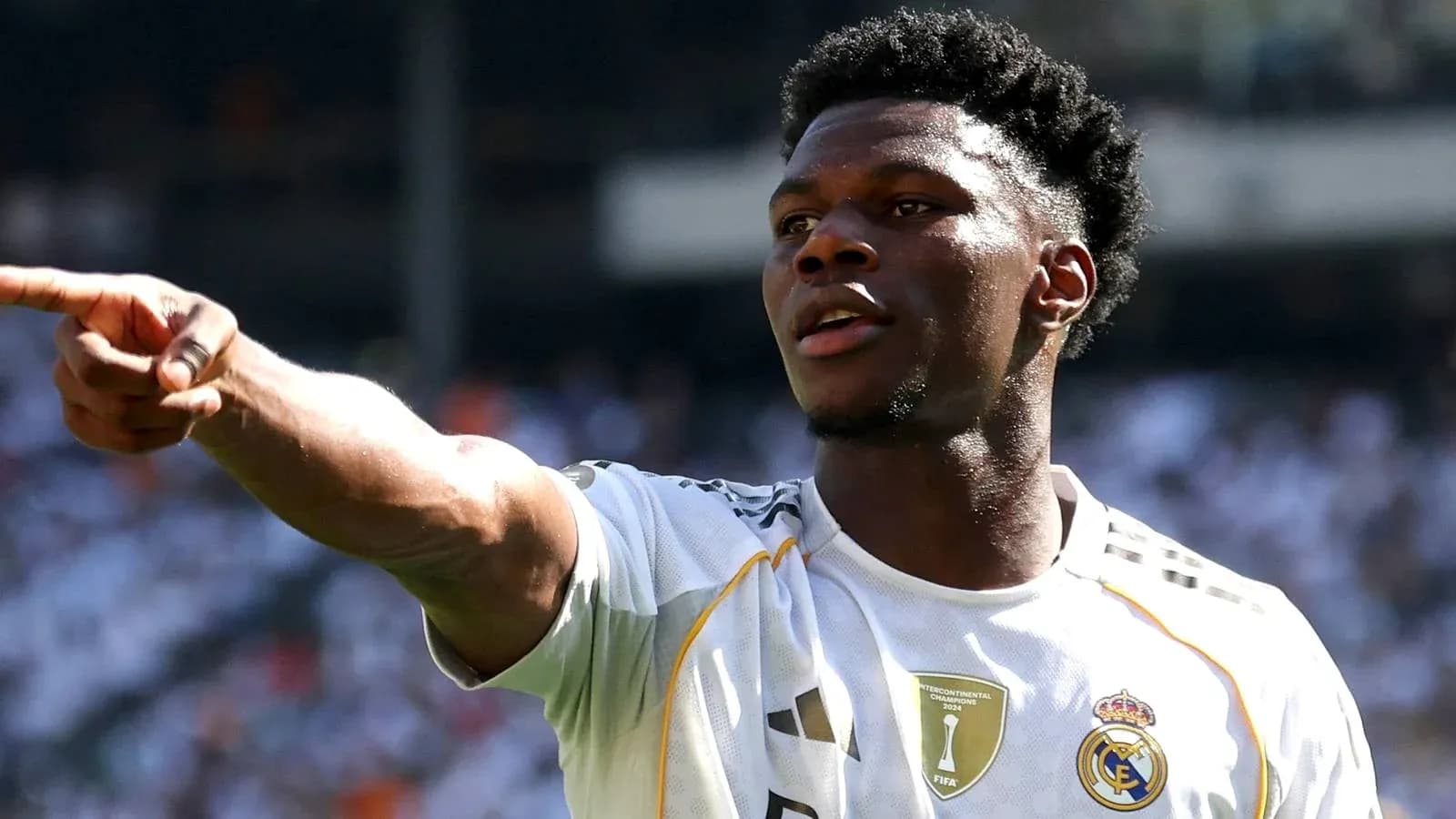 Player pointing during a match wearing Real Madrid jersey