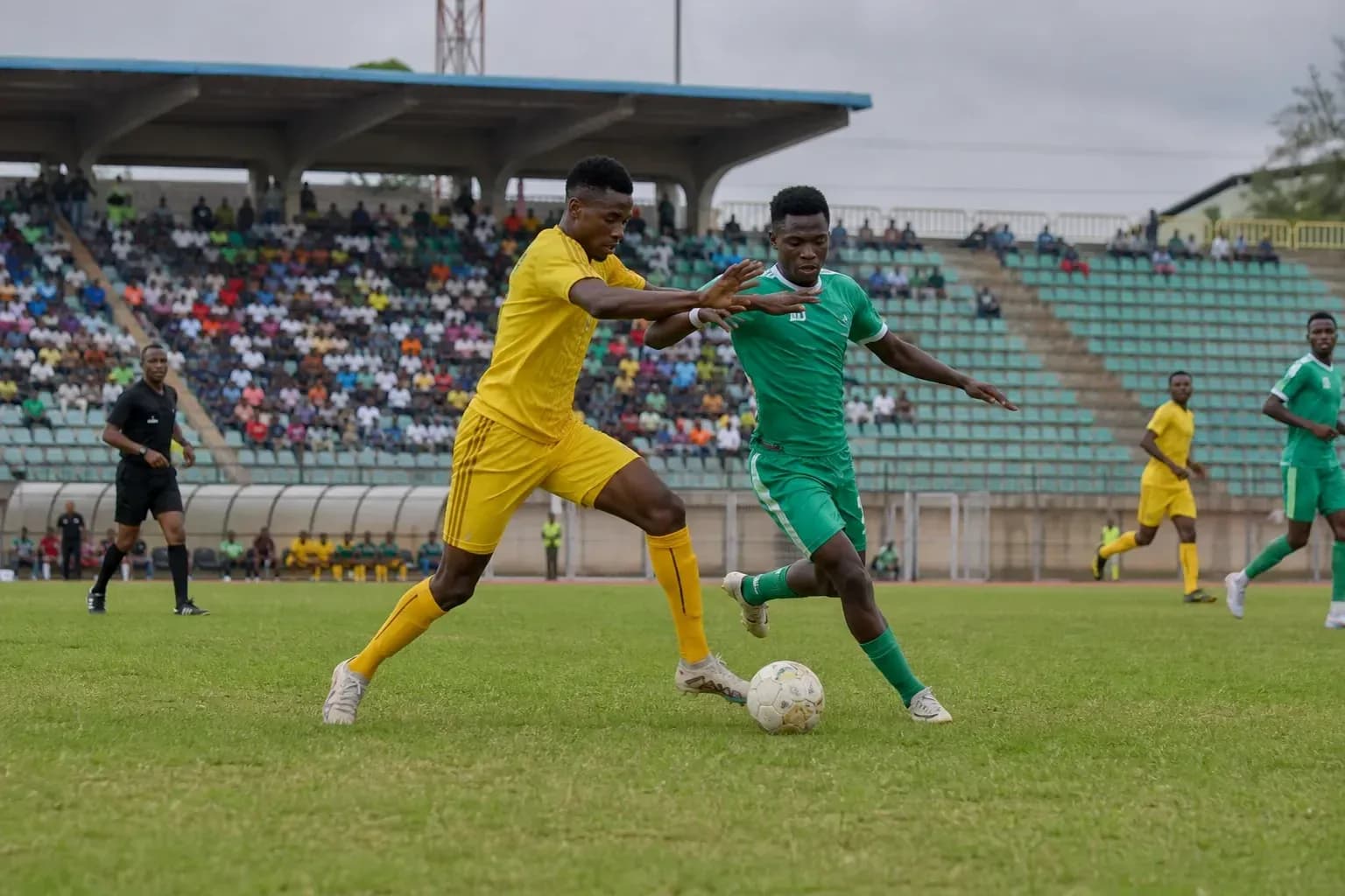 Players competing for the ball in football match