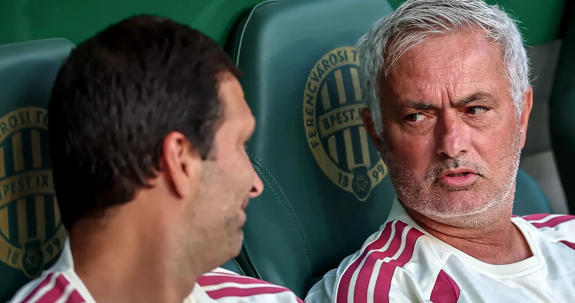 Coaches discussing on the bench during match