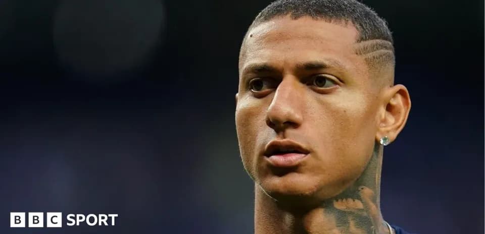 Player with short hair and earrings looking on