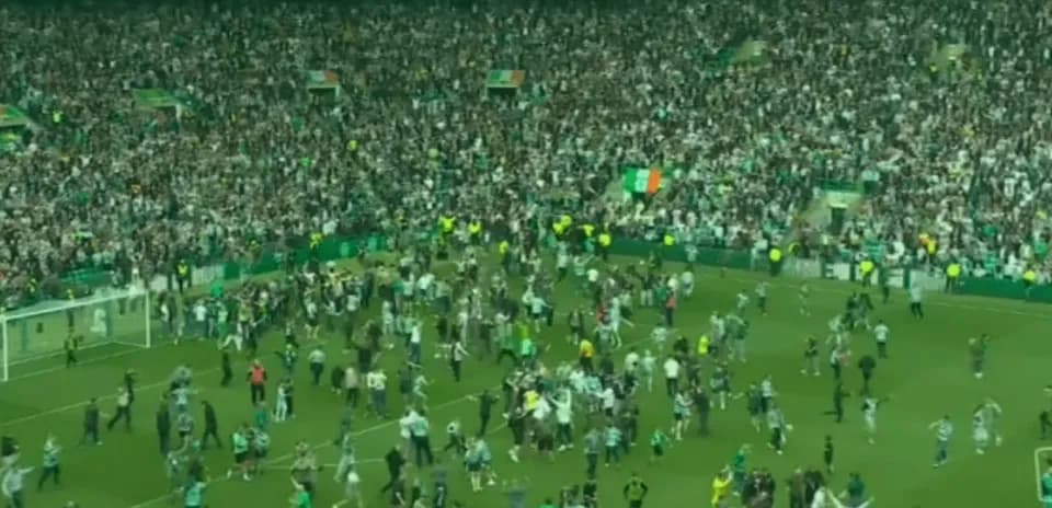 Crowd celebrating on the pitch after match