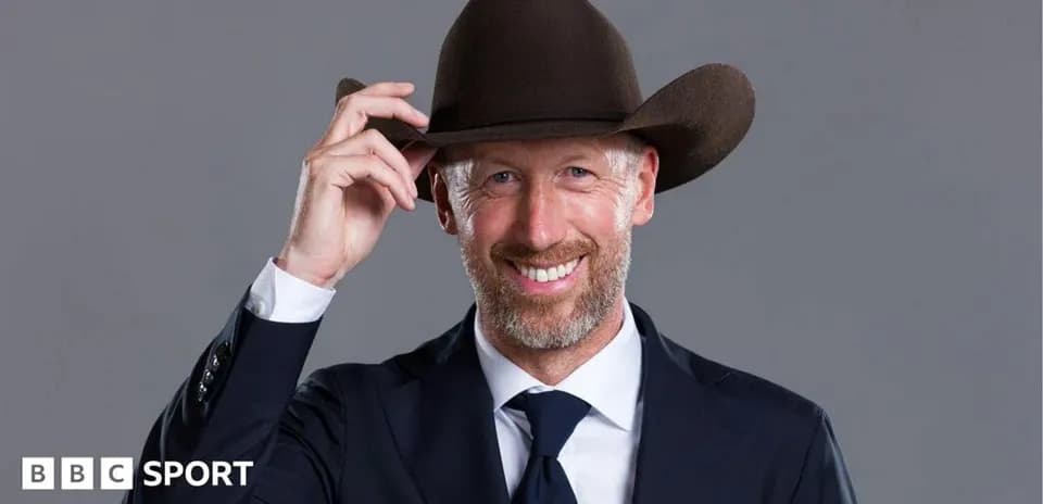 Man in a suit wearing a cowboy hat