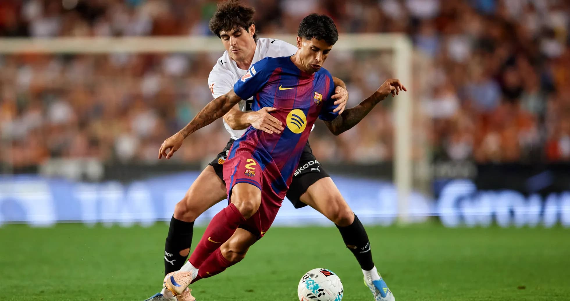 Barcelona player challenged by opponent during match