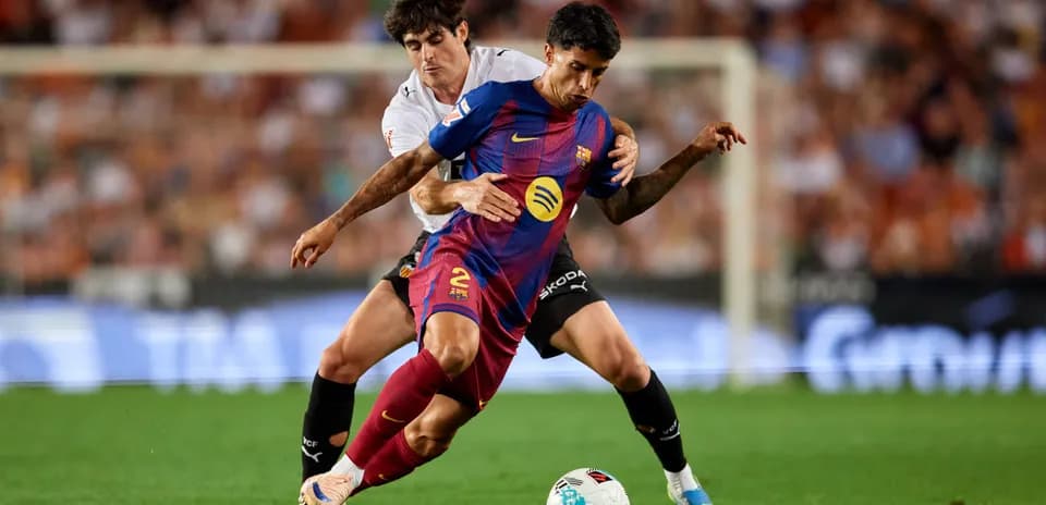 Barcelona player challenged by opponent during match